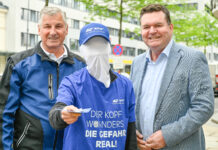 Komm. Rat Peter Engelbrechtsmüller, Vorsitzender der zuständigen AUVA-Landesstelle für Wien/NÖ/Burgenland, ein "kopfloser" Aktionsmitarbeitender, der einen Flyer in Richtung Kamera aussteckt und Dipl.-Ing. Christian Kräutler (KFV).