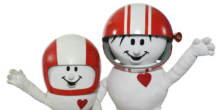 HELMI wie er am Anfang war und die aktuelle Version von HELMI nebeneinander. Sie lächeln und winken in die Kamera.